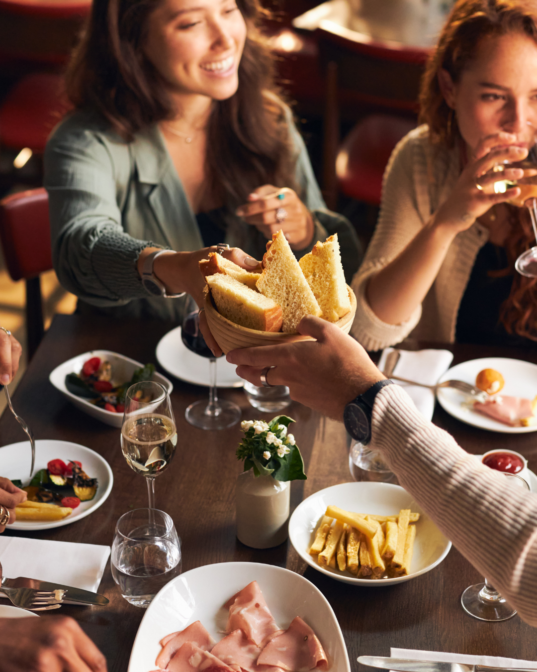 Friends sharing a meal around a restaurant table